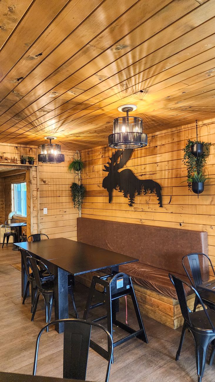 Cozy wood-lodge dining room with moose art at Blue Buffalo Pizzeria