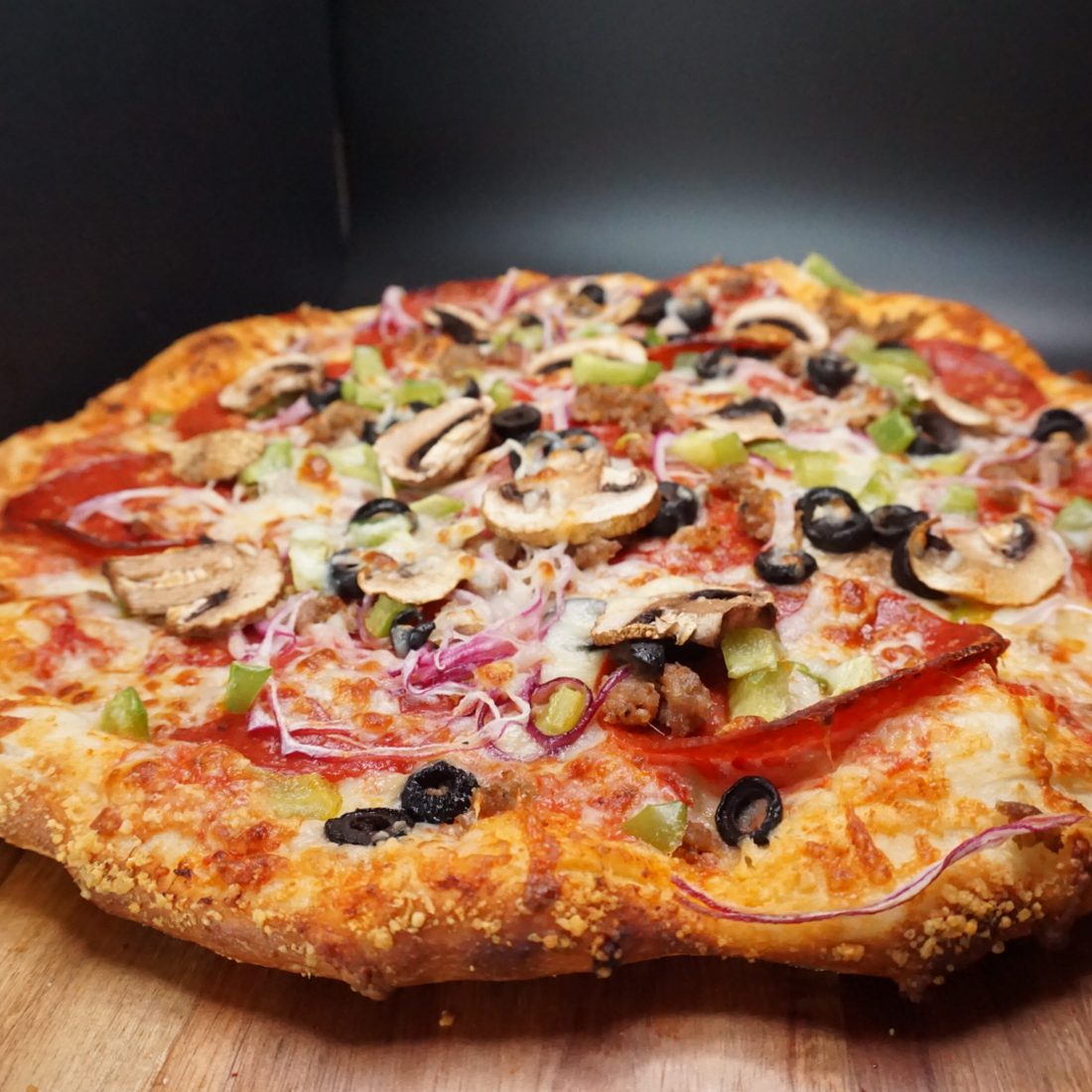 208 Supreme pizza loaded with pepperoni, sausage and vegetables