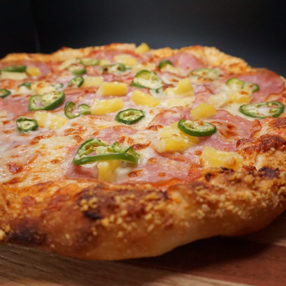 Mad Hawaiian pizza with Canadian bacon, pineapple and jalapeño