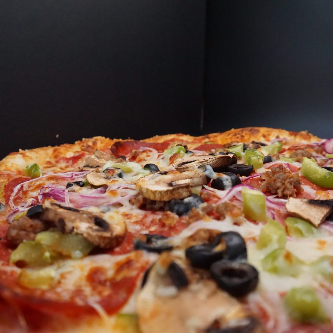 208 Supreme pizza loaded with pepperoni, sausage, peppers, onion, olive and mushroom
