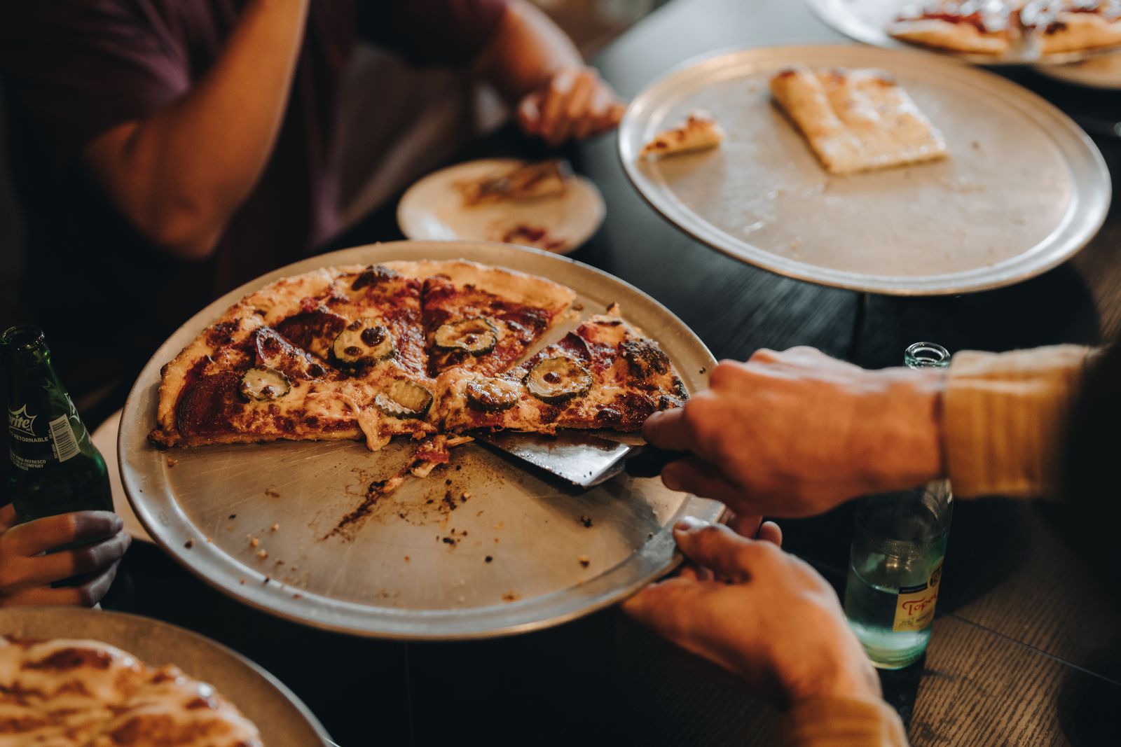 A spread of pizzas shared around the table